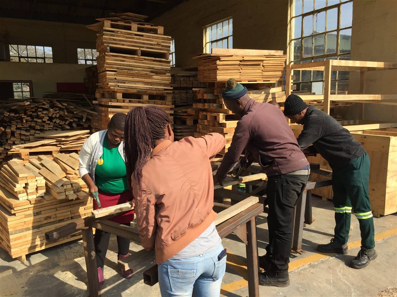 Our community choosing useful timber in the yard