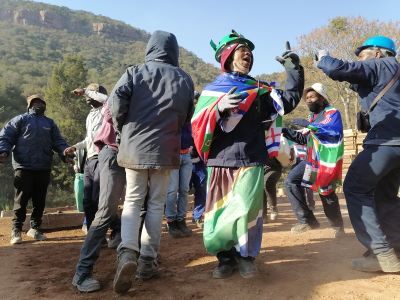 The team singing and dancing together