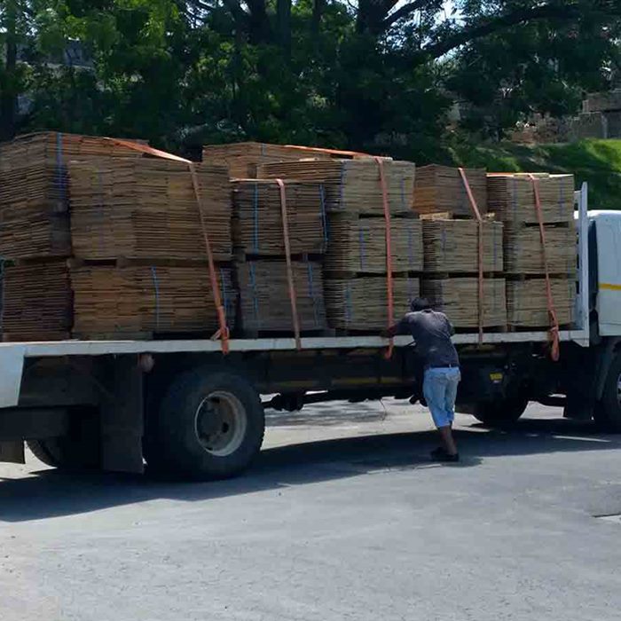 Flat-packed crates strapped on a truck for delivery to a customer