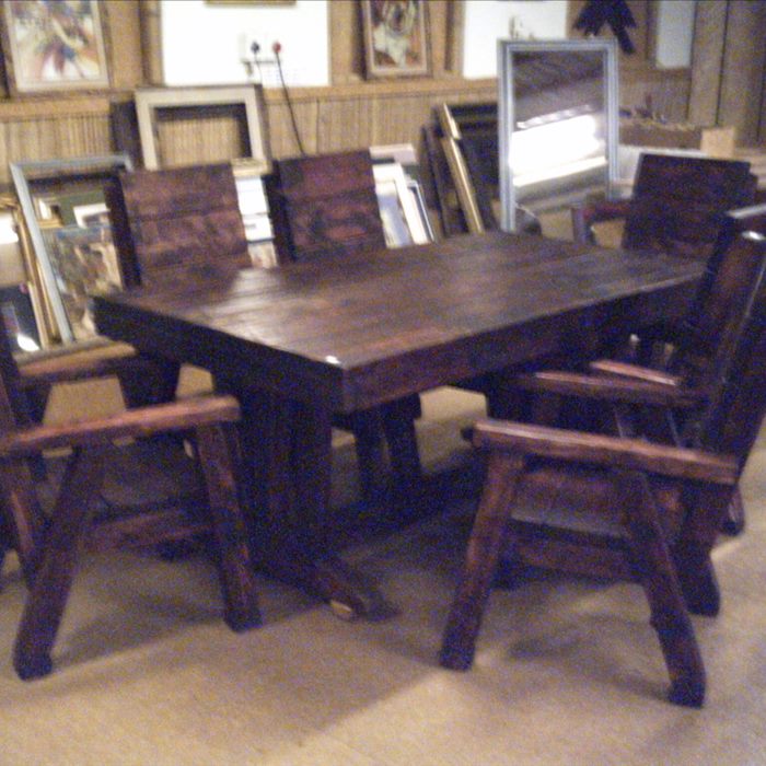 A dining table with carver chairs