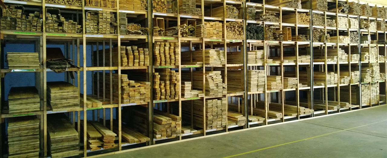 Long racks of reclaimed timber, sorted by size and labelled, in the showroom